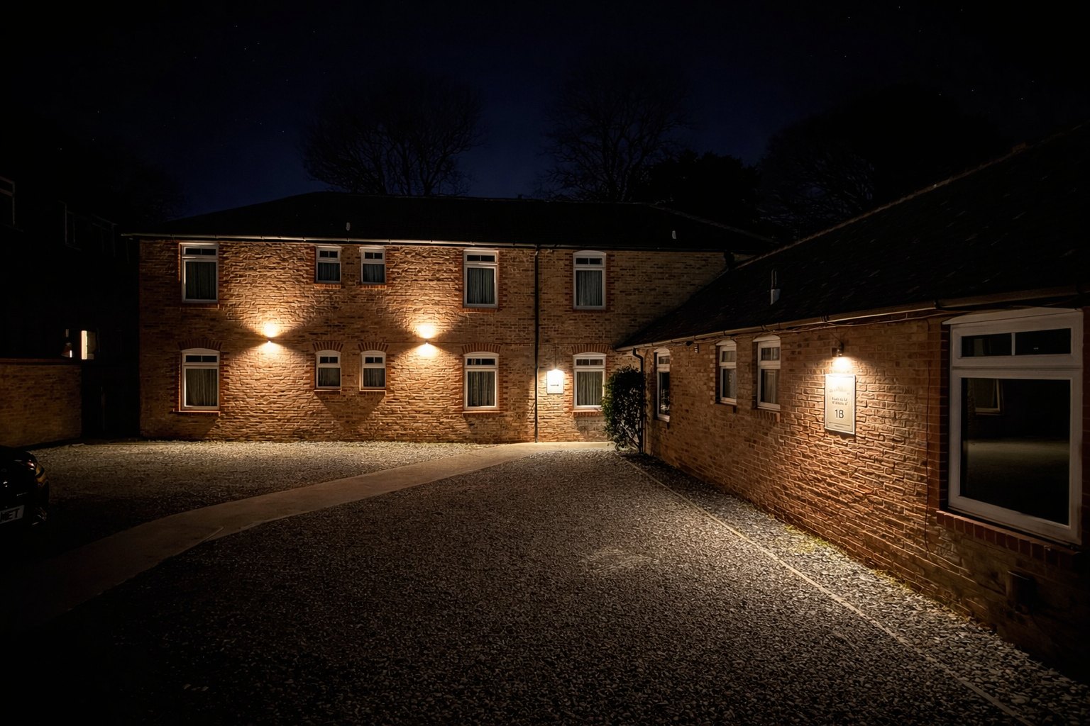 YO10 Accommodation exterior and private parking area at night